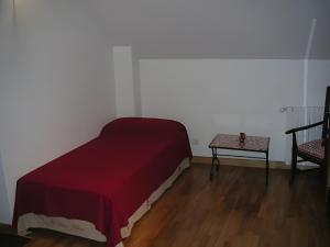 a bedroom with a bed and a table and a chair at Gite Périgourdin - 3 Chambres in Labrousse +11 photos