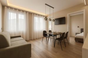 a living room with a table and chairs and a bed at Jacuzzi Luxury Suite Iseo Elegant Apartment with Balcony Central Iseo in Iseo