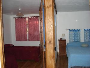 an open door to a bedroom with a bed at Gite Périgourdin - 2 Chambres in Labrousse