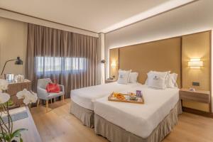 Ένα ή περισσότερα κρεβάτια σε δωμάτιο στο Aravaca Village Hotel
