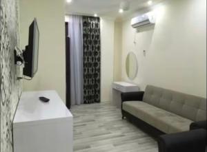 a living room with a couch and a tv in it at Seastar in Kvariati +7 photos