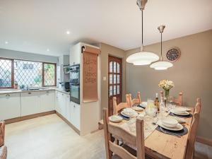 a kitchen and dining room with a table and chairs at Weavers Cottage in Barrowford