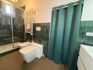 a bathroom with a toilet and a shower and a sink at L'Albero in Bergamo