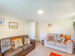 a living room with two couches and a couch at Court End Cottage in Silecroft