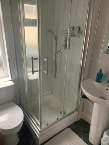 a bathroom with a shower and a toilet and a sink at Alderley Hotel Blackpool in Blackpool +122 photos