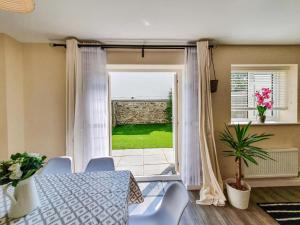 a dining room with a table and a window at Mont Blanc House in Braunton
