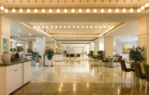 a large lobby with chairs and tables in a building at Qafqaz Baku Residence &Apartment in Mekhrably