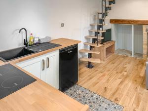 a kitchen with a sink and a dishwasher at Dovecote in Guyhirn