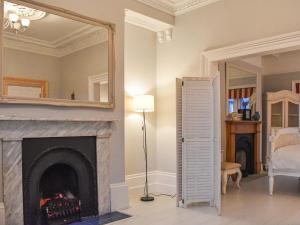 a living room with a fireplace and a mirror at Whitby Bliss in Whitby