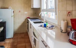 a kitchen with a white counter and a white refrigerator at 3 Bedroom Beautiful Home In Rojales in Rojales