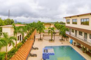 an aerial view of a hotel with a pool and palm trees at River Splash Resort,Karjat in Neral