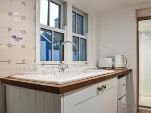 a kitchen with a sink and a window at Whitby Bliss in Whitby