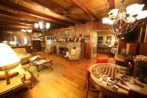 a living room with a table and a fireplace at Grandview Lodge in Waynesville