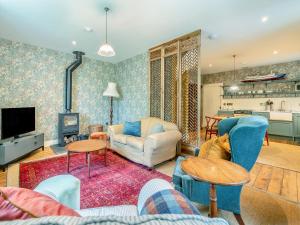 a living room with a couch and a tv at Uk47812 - Wardens Cottage in Kinloch Rannoch