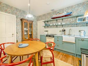 a kitchen with a wooden table and a table and chairs at Uk47812 - Wardens Cottage in Kinloch Rannoch
