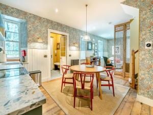 a kitchen and dining room with a table and chairs at Uk47812 - Wardens Cottage in Kinloch Rannoch