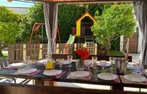 a table with plates and wine glasses on it at Cozy Home In Okrug Gornji With Sauna in Trogir