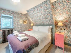 a bedroom with a bed with towels on it at Uk47812 - Wardens Cottage in Kinloch Rannoch +11 photos
