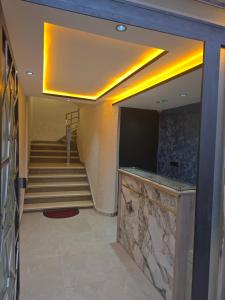 a lobby with a staircase with a television and a stair case at Appartement luxe 3 in Khenifra