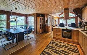 a kitchen and dining room with a table in a house at Lovely Home In Vrådal With Sauna in Vradal