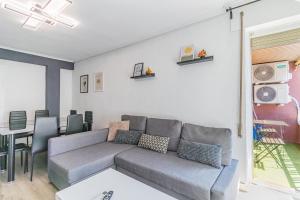 a living room with a couch and a table at Your Large Family Apartment in Zaragoza in Zaragoza +26 photos