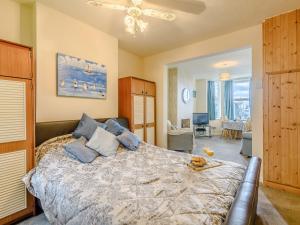 a bedroom with a large bed with blue pillows at Hodges - Uk30761 in Gorleston-on-Sea +8 photos