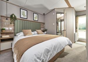 a bedroom with a large bed in a room at Burtree Lakes Holiday Park in Bedale