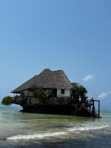 a house on an island in the water at Sisters House in Pingwe
