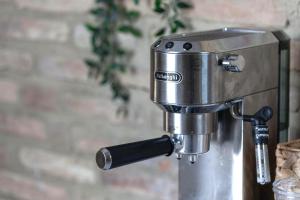a coffee machine sitting on top of a table at Charming Boutique B&B Hotel in Villalfonsina