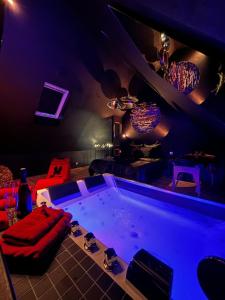 a room with a large tub in a dark room at La Sainteny Touch in Sainteny