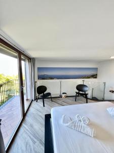 a bedroom with a bed and a balcony at Domus Minerva in Massa Lubrense