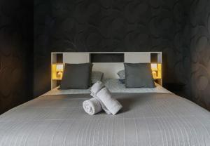a bedroom with a bed with towels on it at Le Sainte Barbe - Hyper Centre - Parc des sources in Vichy