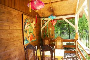 a room with chairs and a painting on the wall at Domek Wróżki - Sanktuarium Laparica w Puszczy Białej  +25 photos