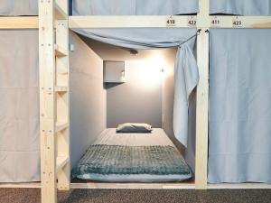 a bunk bed in a room with a ladder at MATSUMOTO CASTLE hostel in Matsumoto +23 photos