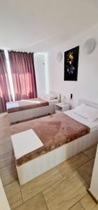 a bedroom with a large bed and a couch at Hotel Jolie in Brazii de Sus +84 photos