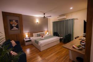 a bedroom with a bed and a living room at INDUS TIARA- A Corporate Boutique Hotel in Siliguri +79 photos