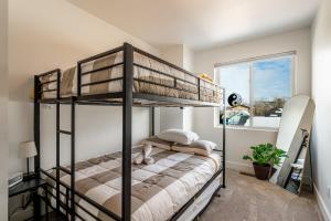 ein Schlafzimmer mit Etagenbett und Fenster in der Unterkunft The Zen Den - Sauna Sleeps 15 & King Bed - Health Amenities in Sheridan