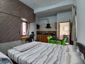バンガロールにあるStudio Room in Bengaluruの大きなベッドとキッチンのある寝室