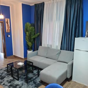 a living room with a couch and a table at Comfort Corner in Amdalai