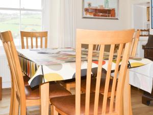 a dining room table with a table cloth on it at Church St 1 Upper Apartment - Cottage in Salcombe +8 photos