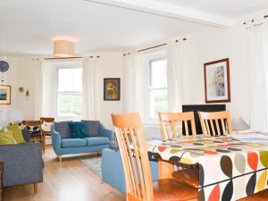 a dining room and living room with a table and chairs at Church St 1 Upper Apartment - Cottage in Salcombe