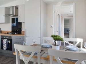 a kitchen and dining room with a table and chairs at Lodge 10 Bridlington Holiday Park - Uk48212 in Carnaby