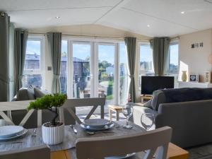 a living room with a table with glasses on it at Lodge 10 Bridlington Holiday Park - Uk48212 in Carnaby