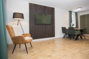 a living room with a chair and a table at UplandParcs W3 in Winterberg