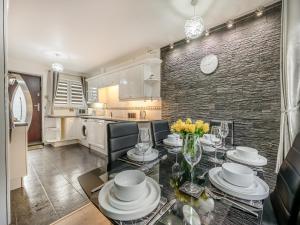 a kitchen and dining room with a table and chairs at Cherrytrees in Scarborough