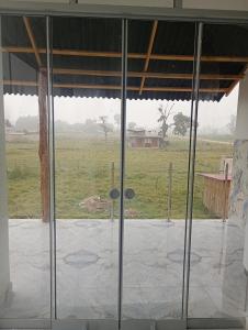 an open glass door with a view of a field at Casa campo in Oxapampa