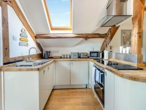 a kitchen with white cabinets and a window at Walker's Retreat - Uk45415 in Eaton Bishop +8 photos