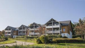 a row of apartment buildings in a park at UplandParcs W3 in Winterberg +41 photos