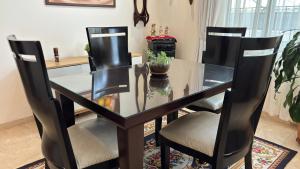 a dining room table with two chairs and a glass table at Casa Boutique Familia Hurtado in Manizales