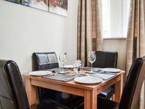 a wooden table with black chairs around it at Chapel Mouse Cottage in Cockermouth +9 photos
